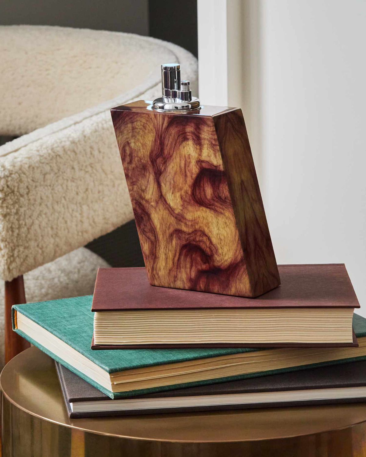 Wooden tabletop lighter on top of books on a table