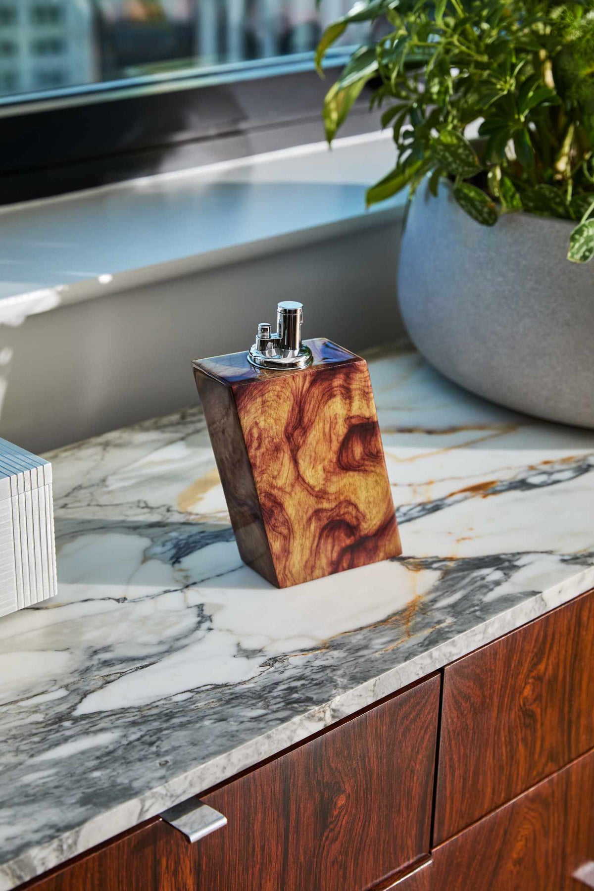 Wooden tabletop lighter on a marble countertop with a blurred background